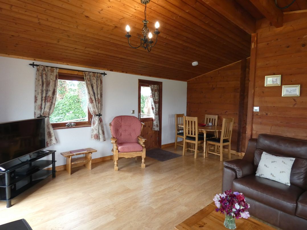 A living room with a television and seating area at Chestnut Lodge in Pilling