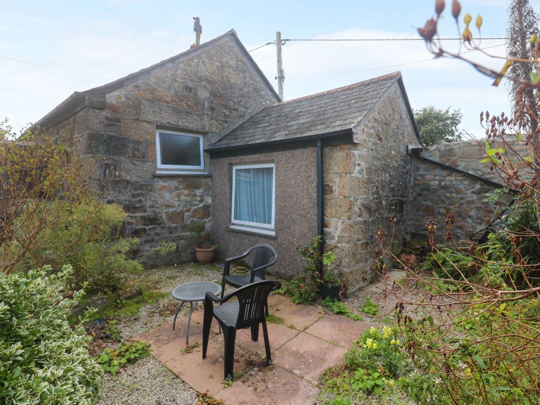 A garden area with a table and chairs near a cottage at Chyancrowse in Gulval