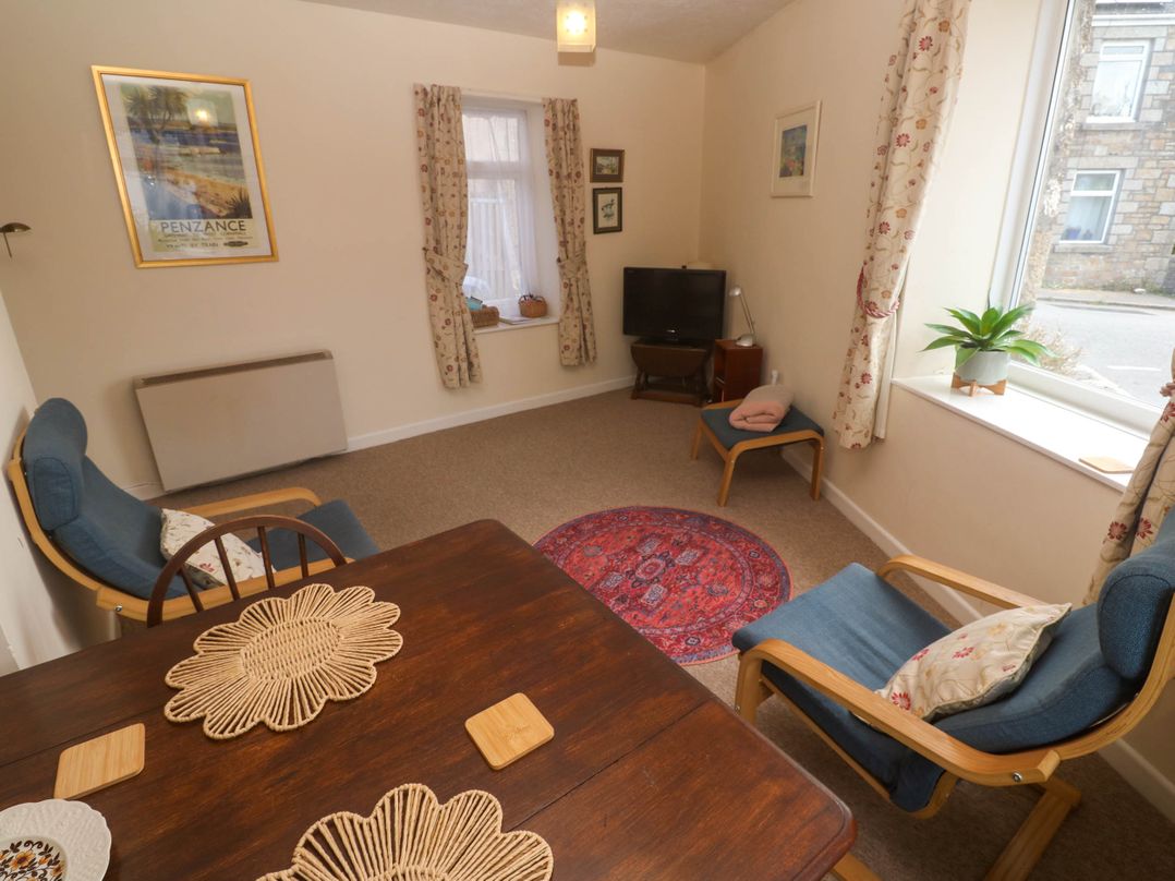 A living room with a table and chairs at Chyancrowse in Gulval