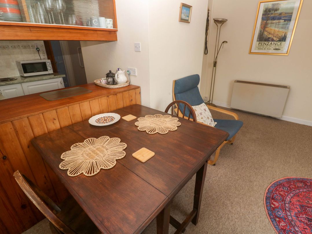 A dining room with a table and chairs at Chyancrowse in Gulval