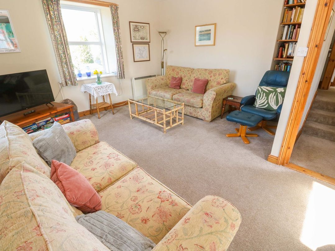 A living room with a sofa and television at Chyandaunce in Penzance