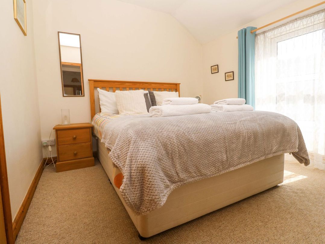 A bedroom with a bed and nightstand at Chyandaunce in Penzance