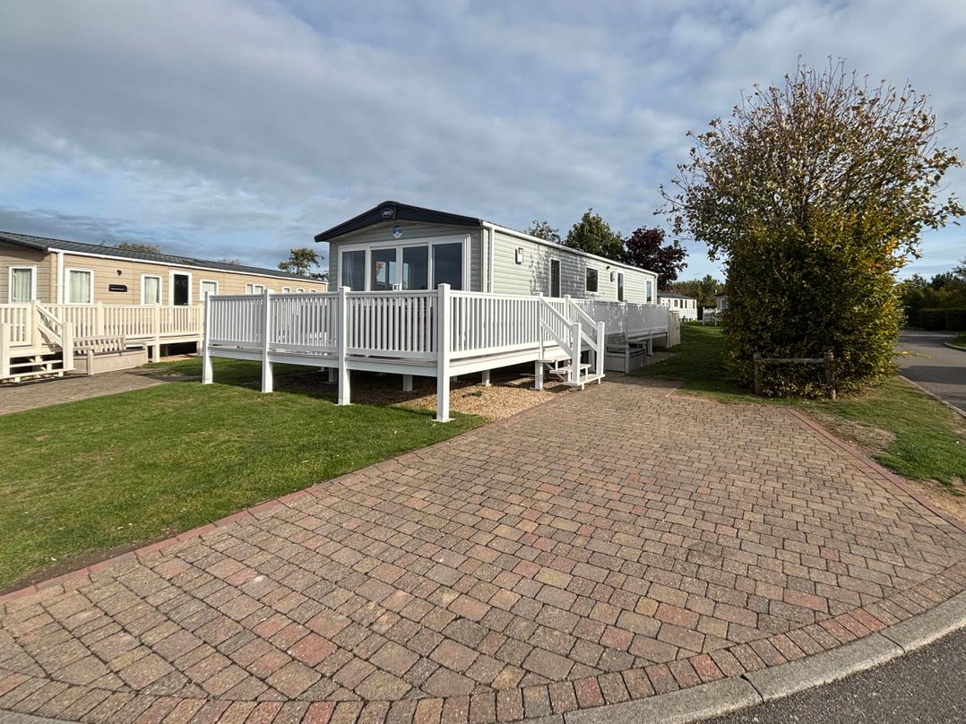 A mobile home with a deck and steps at Primrose Valley Park - Pebbles Retreat, Primrose Valley