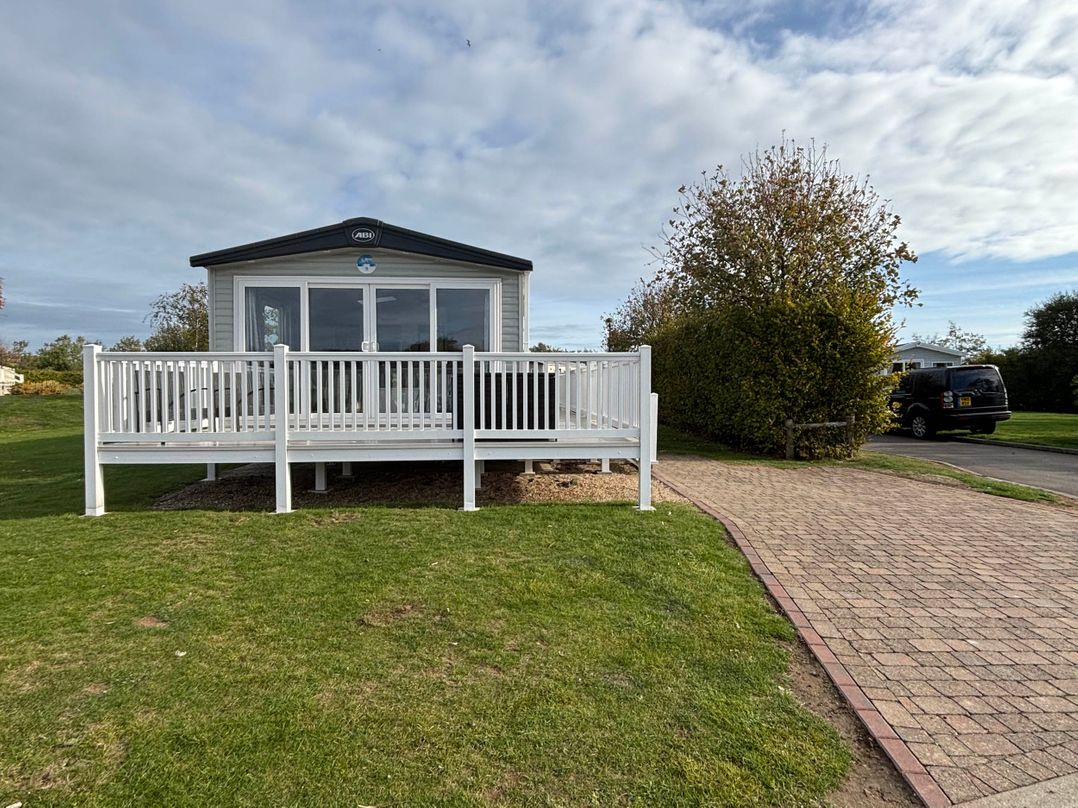 A cabin with decking and a walkway at Primrose Valley Park - Pebbles Retreat in Primrose Valley