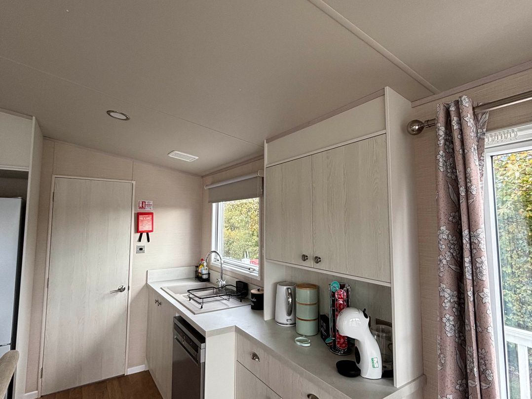 A kitchen with cabinets and a sink at Primrose Valley Park - Pebbles Retreat in Primrose Valley