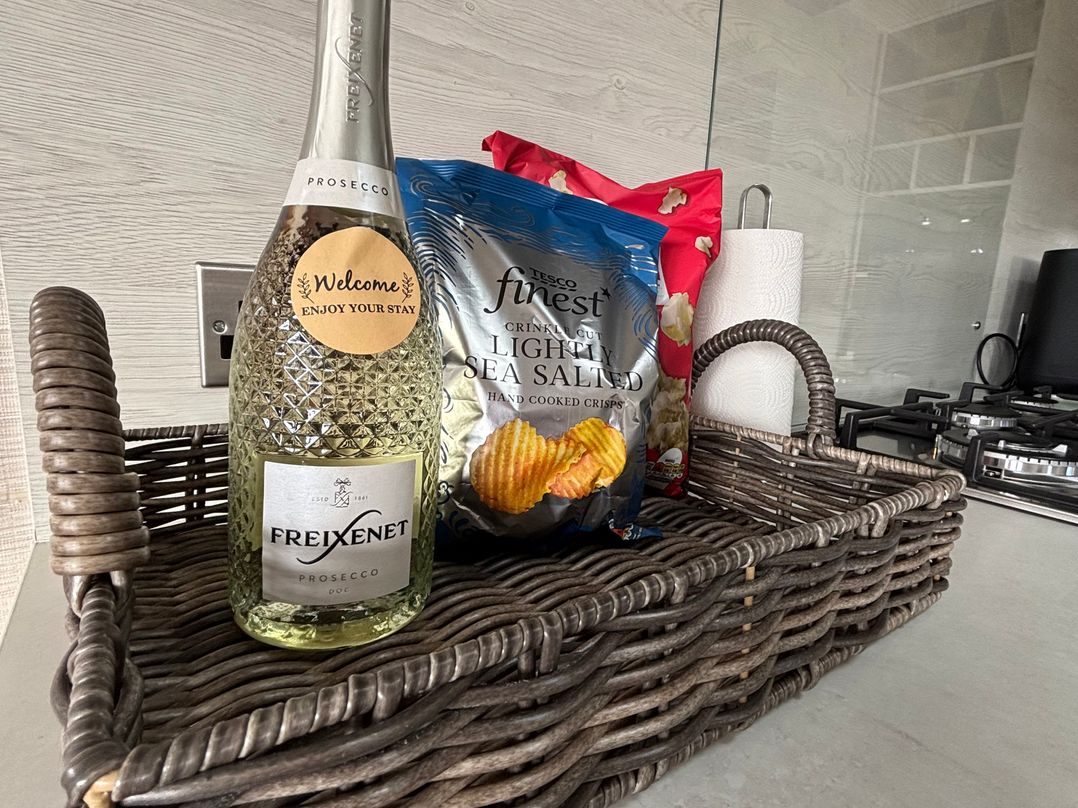 A basket containing prosecco, crisps, and popcorn at Primrose Valley Park - Pebbles Retreat in Primrose Valley