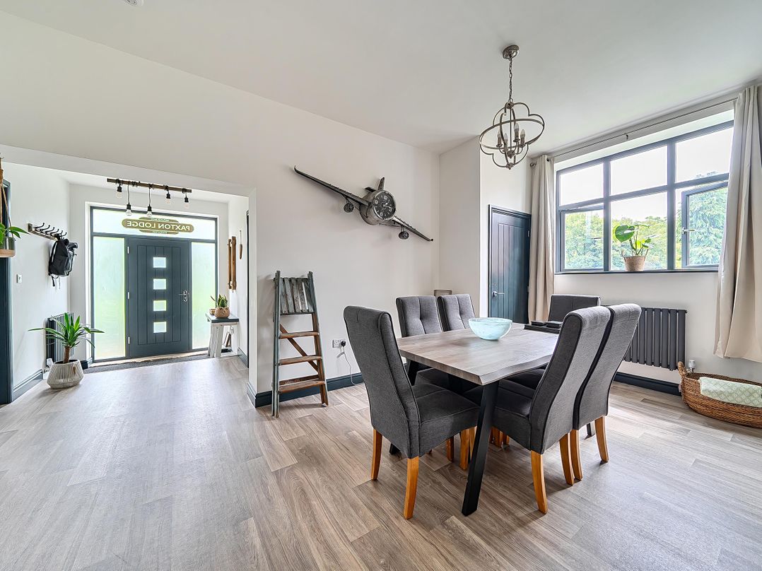 A dining room with a table and chairs at PAXTON LODGE in Matlock Bath