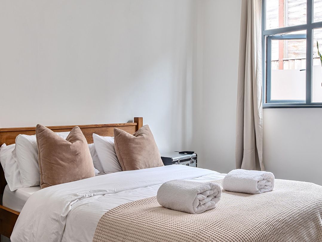 A bedroom with a bed and pillows at Stunning Retreat in the Heart of Matlock Bath Matlock Bath near Matlock