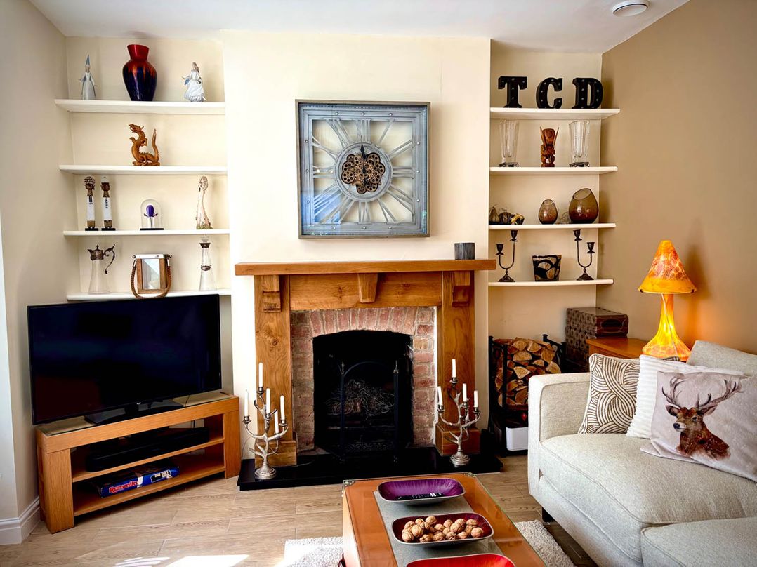 A living room with a fireplace and a television at 5 Guests  2 Bedrooms  Free Parking 1min Beach Llandudno