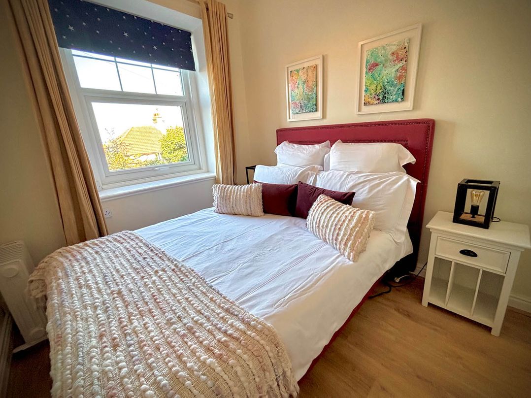 A bedroom with a bed and bedside table at 5 Guests  2 Bedrooms  Free Parking 1min Beach in Llandudno