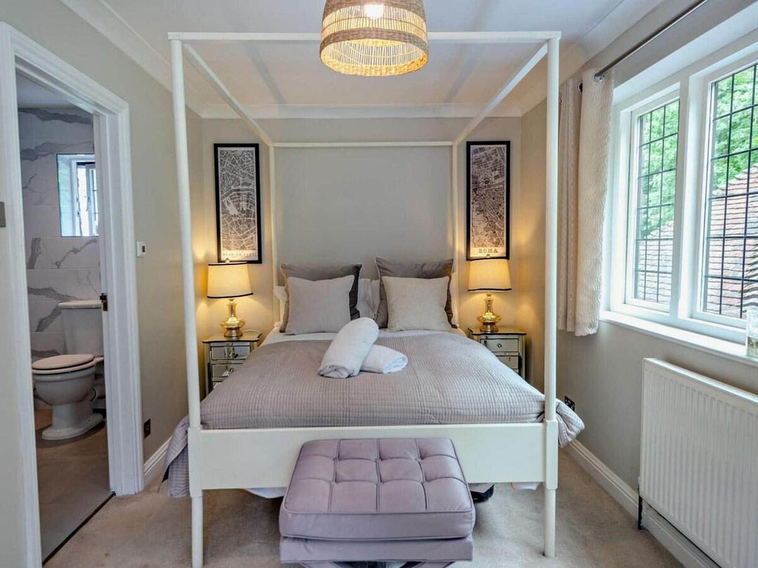 A bedroom with a four-poster bed and bedside tables at Luxurious 5 Bedroom House in Cookham near Marlow