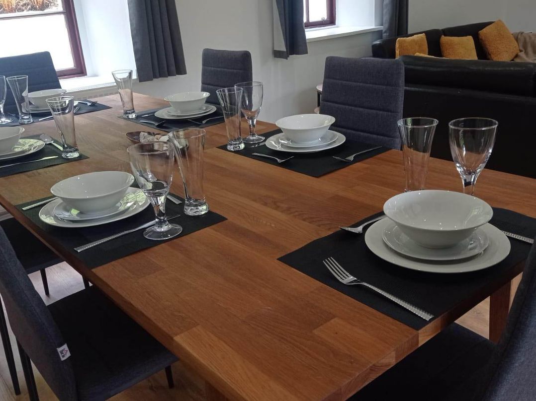 A dining room setup with dishes and glasses at RnB Rural n Beautiful Near Barrhill