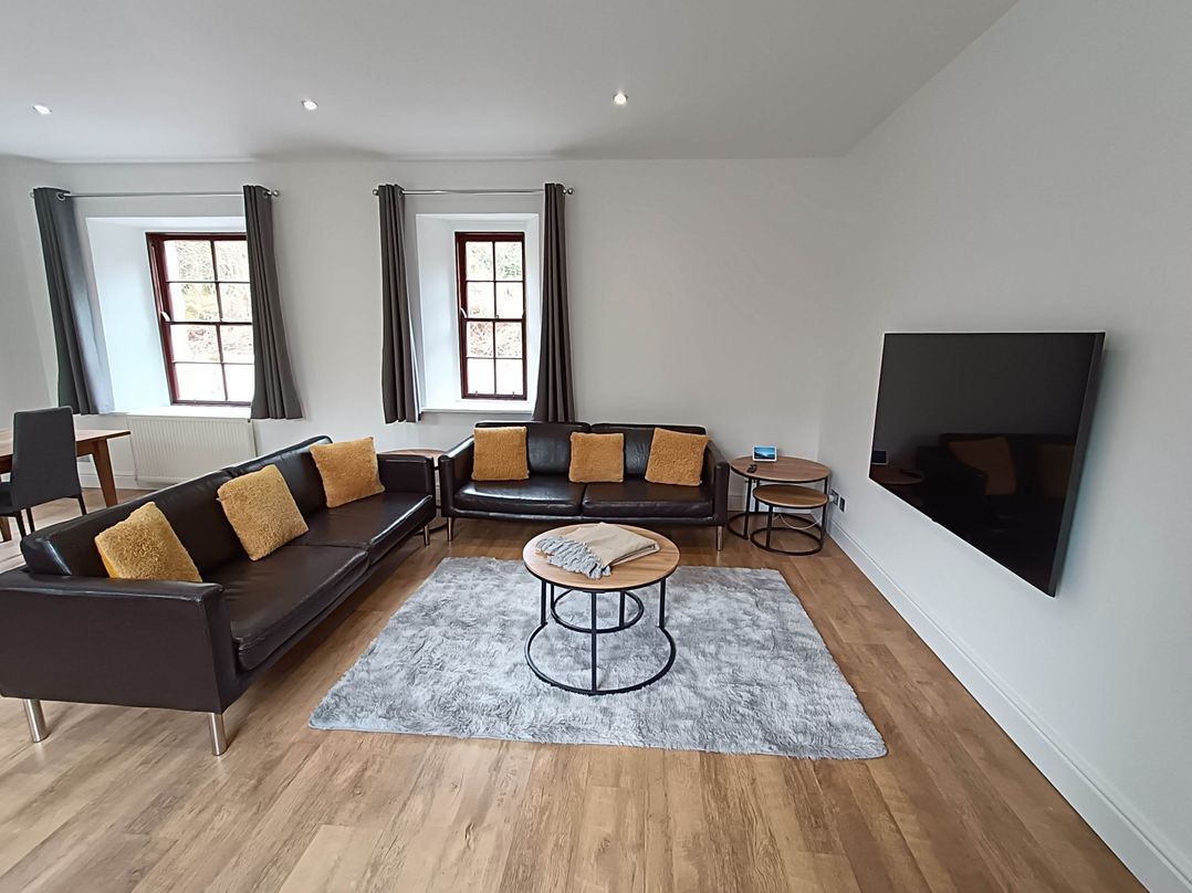 A living room with sofa and coffee table at RnB Rural n Beautiful Near Barrhill