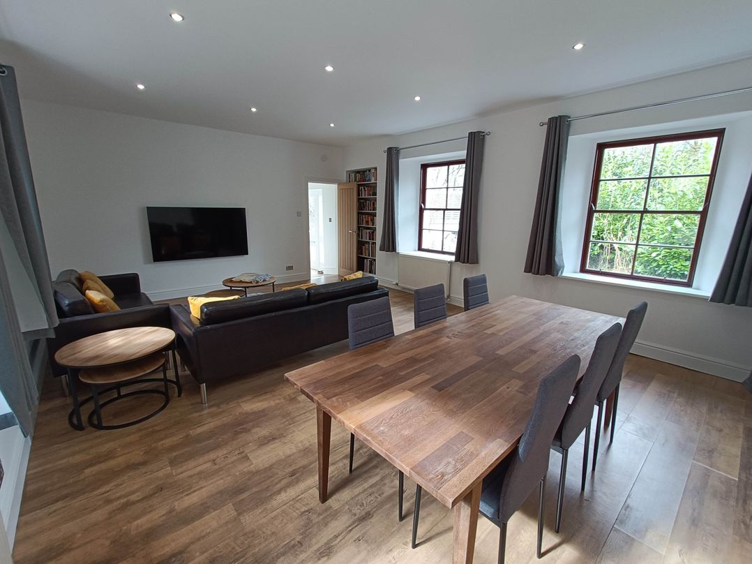 A living room with a dining table and sofa at RnB Rural n Beautiful Near Barrhill