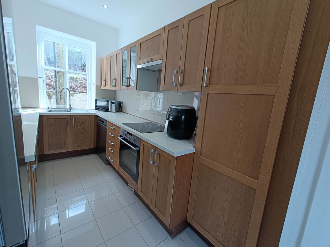A kitchen with cabinets and appliances at RnB Rural n Beautiful Near Barrhill