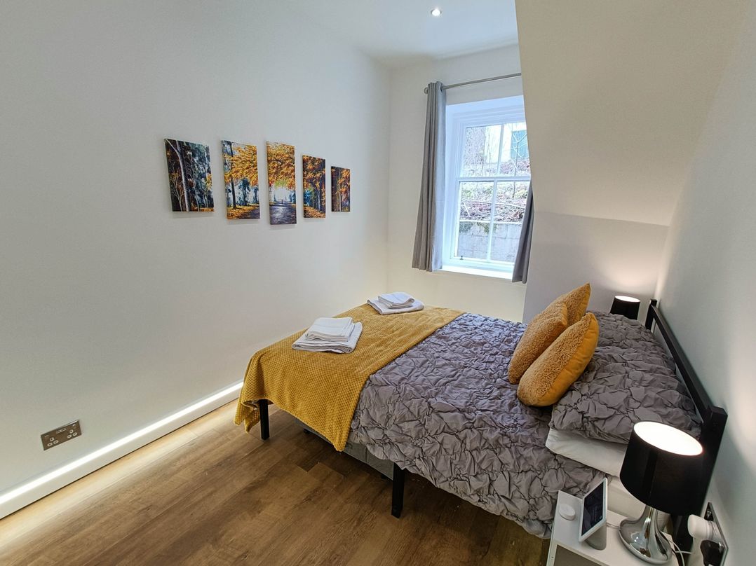 A bedroom with a bed and wall art at RnB Rural n Beautiful Near Barrhill