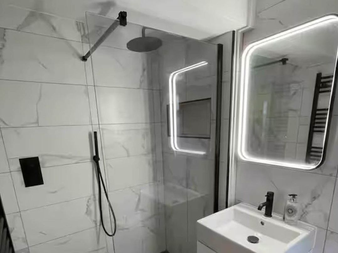 A bathroom with a shower and sink at Hot tub  BBQ  Garden Parking  Sleeps 8 Worcester