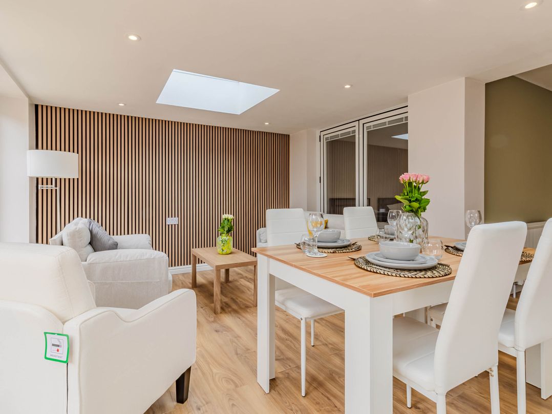 A dining room with a table set for meals at Loughborough Luxe Bungalow Retreat Sleeps 6 in Shepshed
