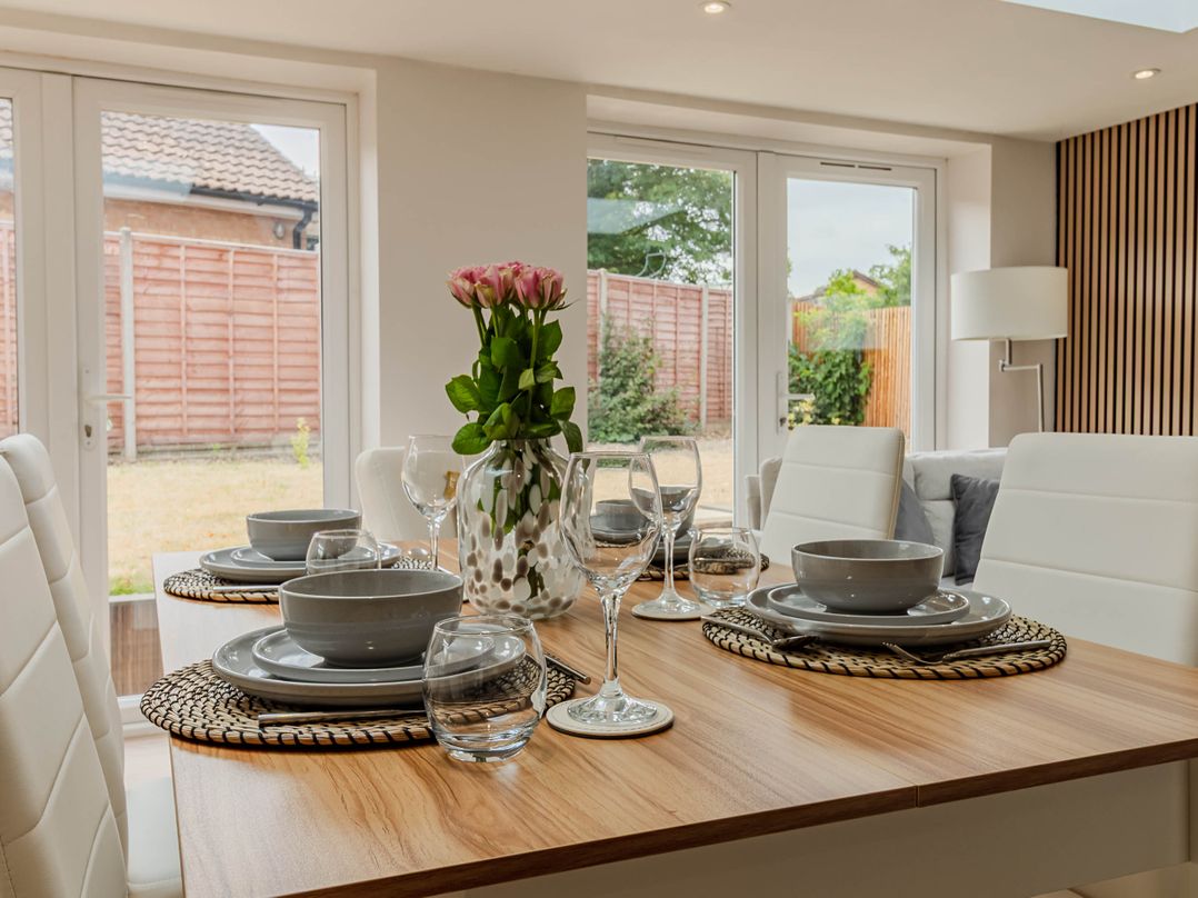 A dining room with a table set for meals at Loughborough Luxe Bungalow Retreat Sleeps 6 in Shepshed