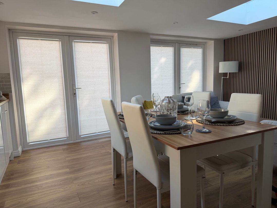 A dining room with a table set for meals at Loughborough Luxe Bungalow Retreat Sleeps 6 Shepshed