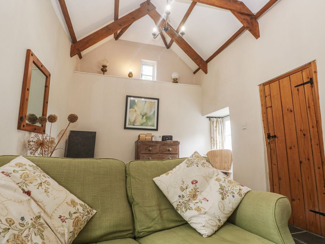 A living room with a sofa and chest of drawers at Swallows St Keverne Lizard Peninsula