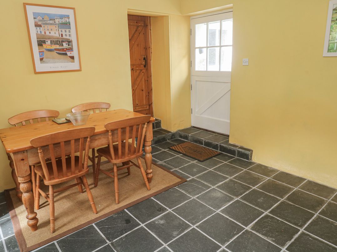 A dining room with a table and chairs at Swallows, St Keverne, Lizard Peninsula