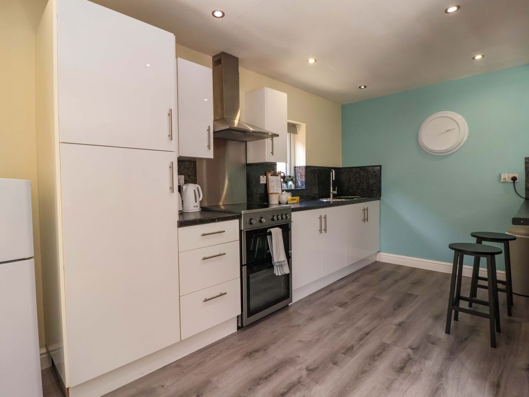 A kitchen with cabinets and a stove at The Granary in York