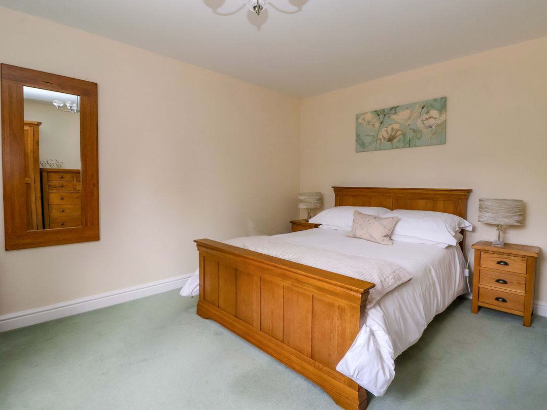 A bedroom with a bed and mirror at The Granary in York