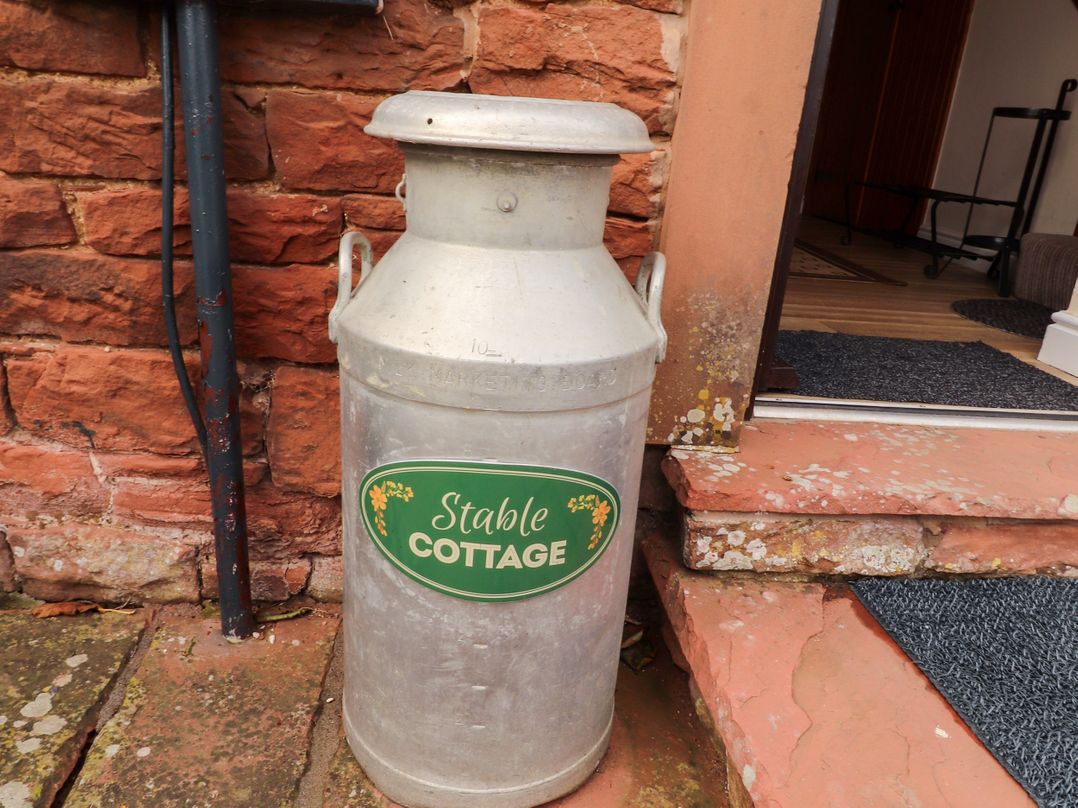 A milk can next to steps at Stable Cottage in Bolton Low Houses