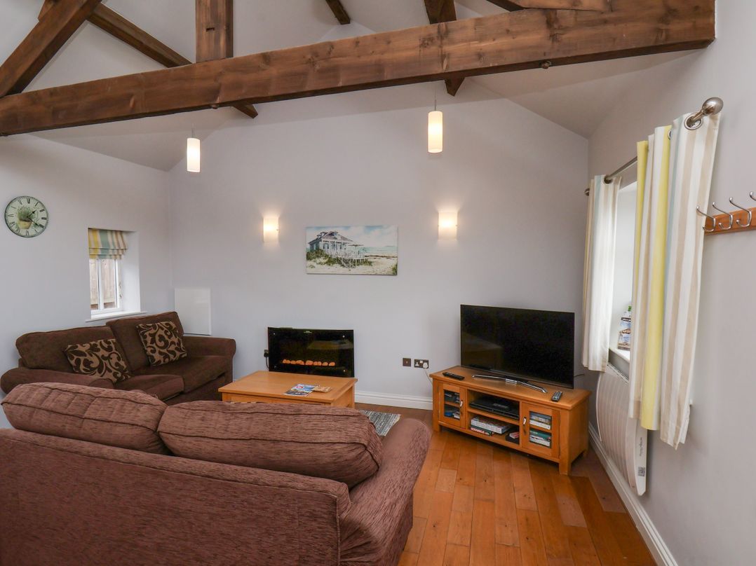 A living room with a sofa and television at Beacon in Gerrick near Moorsholm