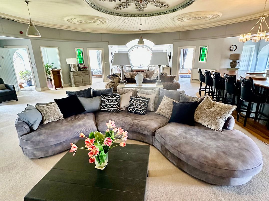 A living room with a sectional sofa and coffee table at Capel Mawr Llanrug near Llanberis