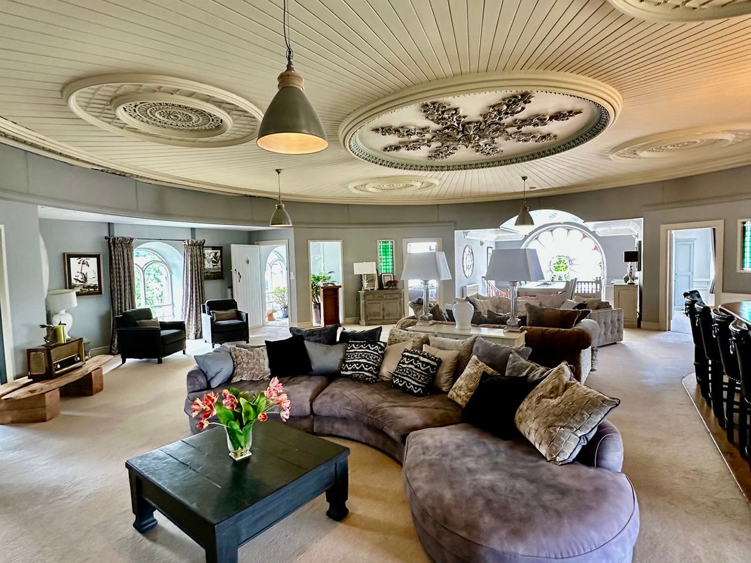 A living room with a sofa and coffee table at Capel Mawr in Llanrug near Llanberis