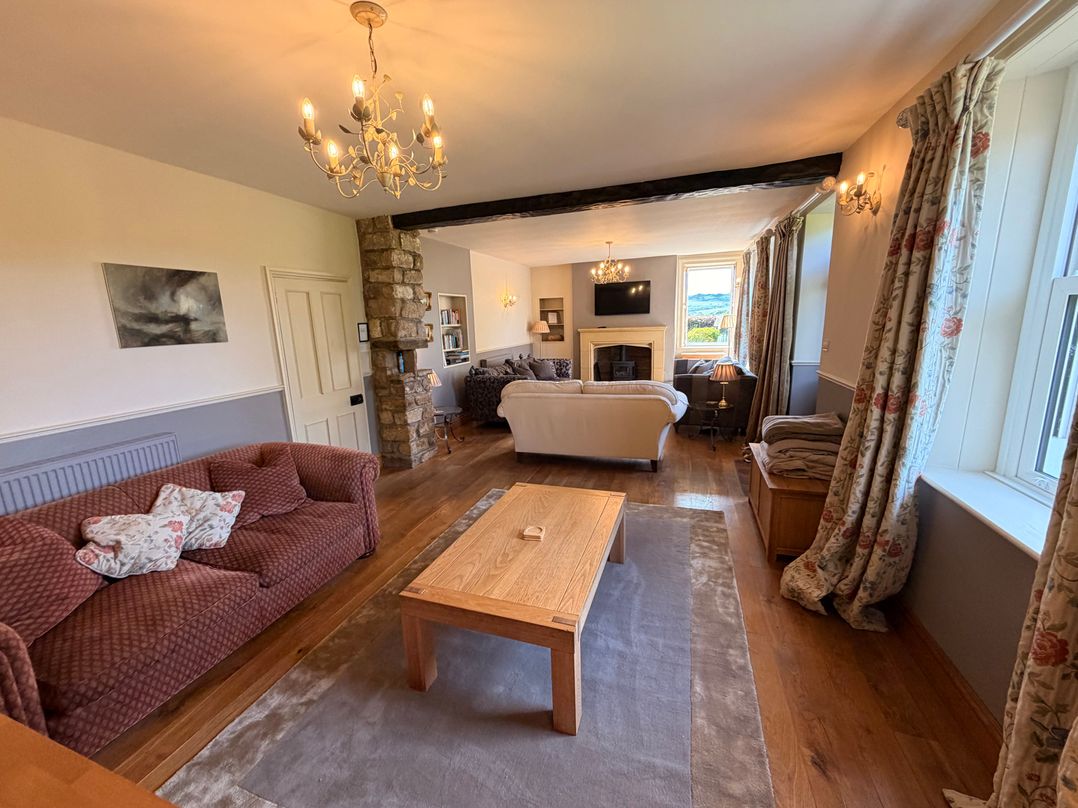 A living room with a sofa and coffee table at The Farmhouse in Boggle Hole near Robin Hood's Bay