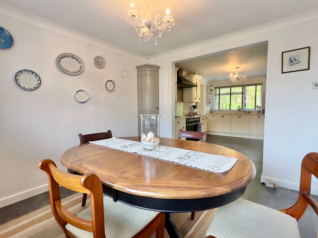 A dining room with a table and chairs at Kilcarreg in Rock near Wadebridge