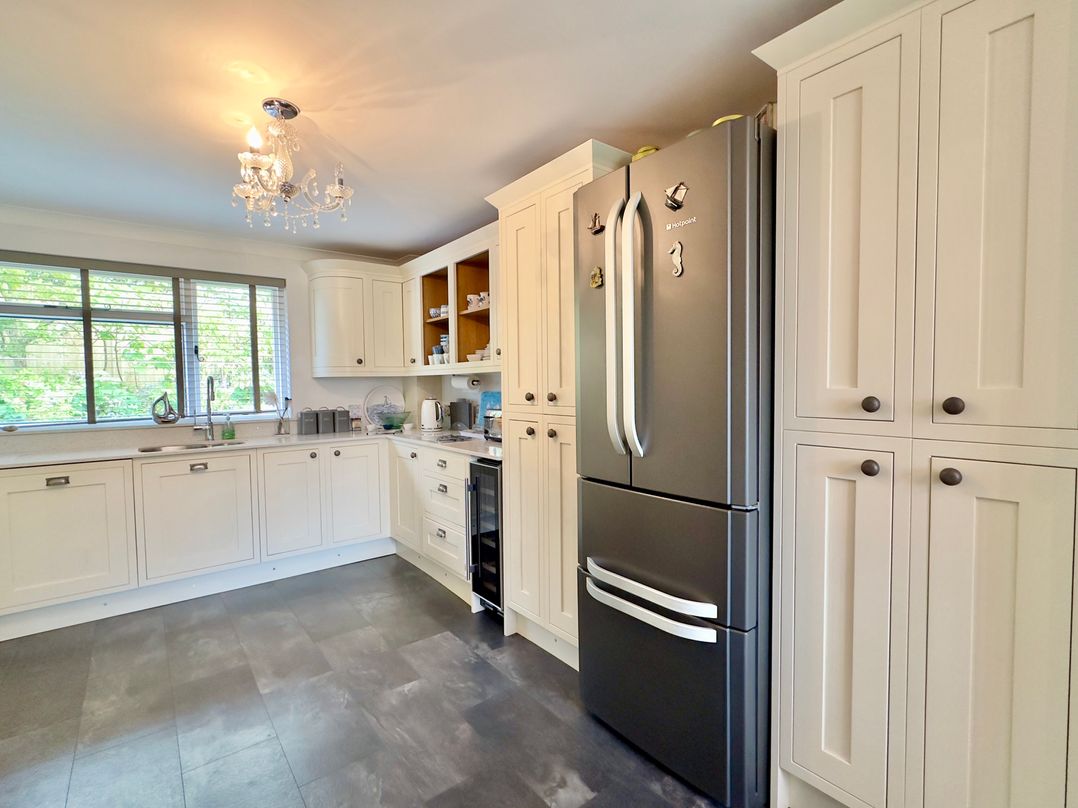 A modern kitchen with a refrigerator and sink at Kilcarreg Rock near Wadebridge