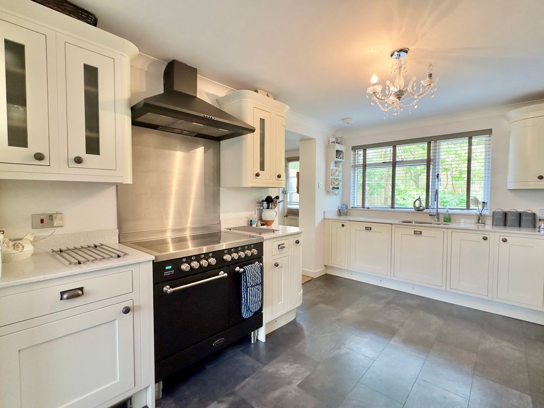 A kitchen with cabinets and an oven at Kilcarreg in Rock near Wadebridge