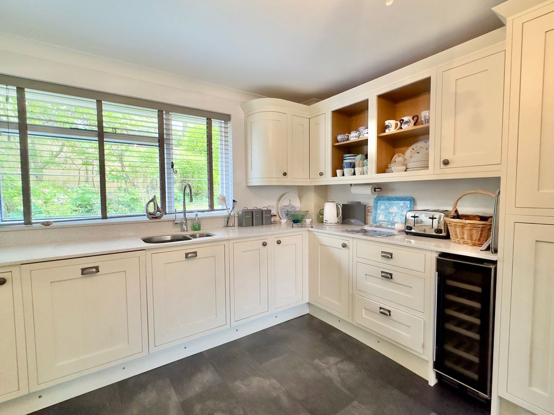 A kitchen with cabinets and appliances at Kilcarreg in Rock near Wadebridge