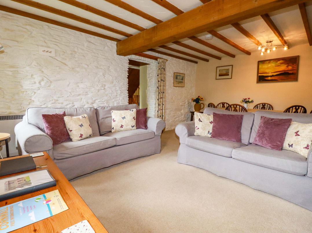A living room with sofas and a dining area at 4 Mowhay Cottages Gorran Haven