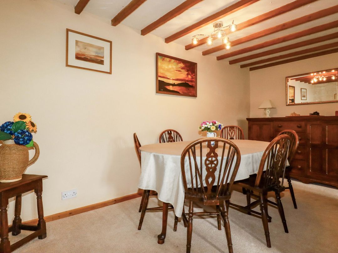 A dining room with a table and chairs at 4 Mowhay Cottages Gorran Haven
