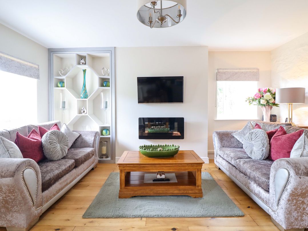 A living room with sofas and a coffee table at Moelfre Cottage Llanbedr