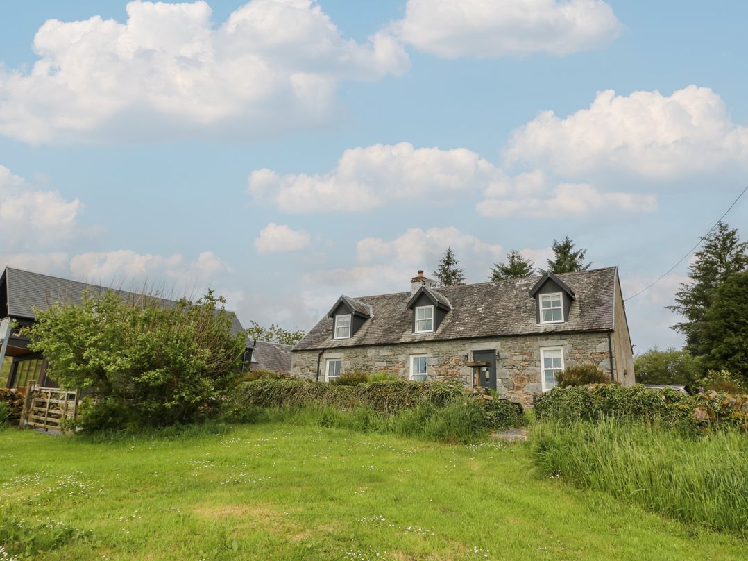 A house with grass and trees at Corrafeckloch Forest Cottages Glentrool near Newton Stewart
