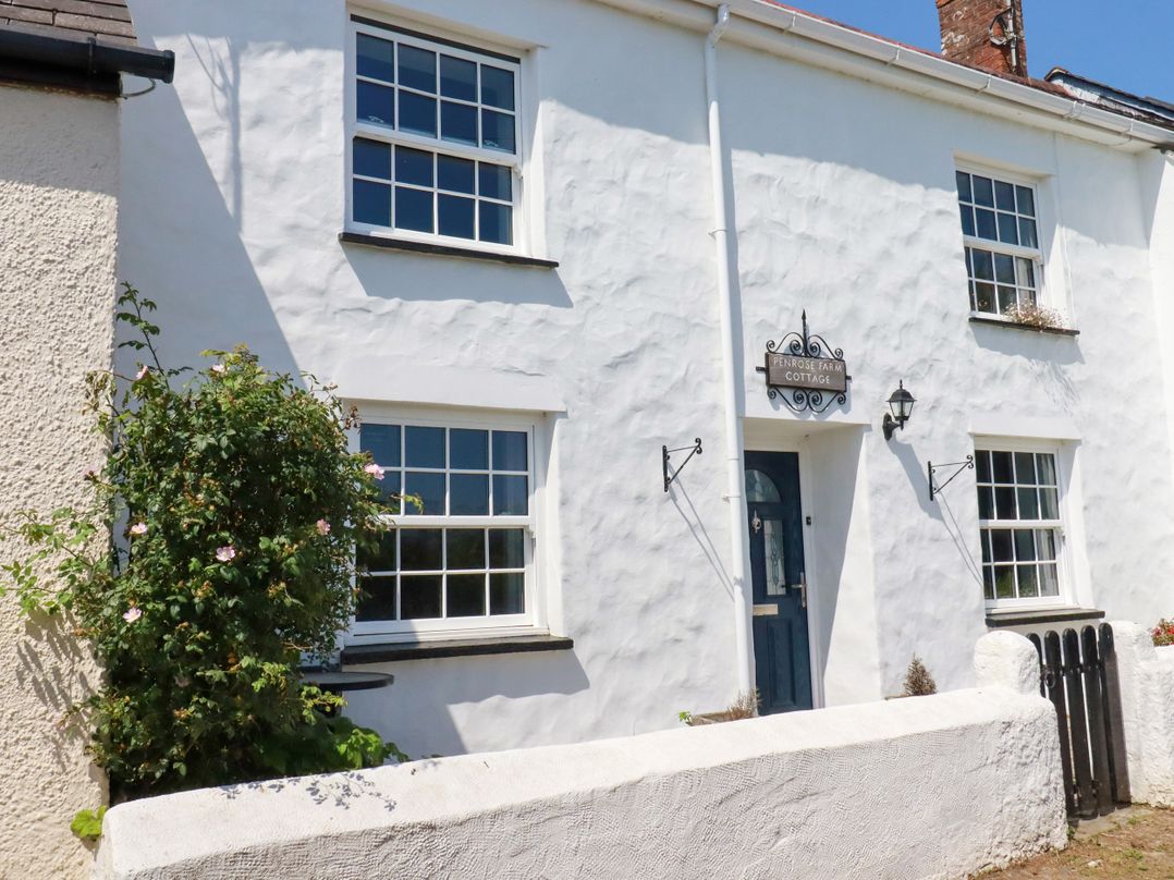 A cottage exterior with windows and a door at Penrose Farm Cottage St Keverne