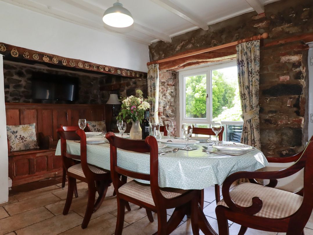 A dining room with a table and chairs at Penrose Farm Cottage St Keverne