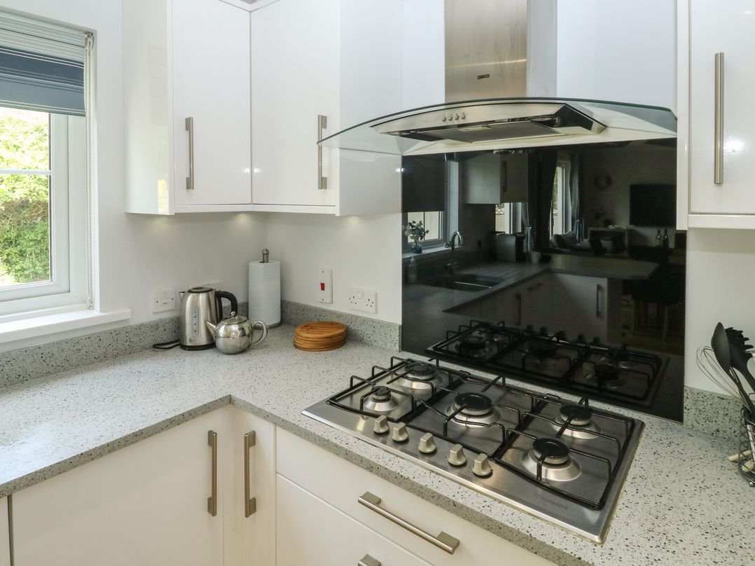 A kitchen with a stove and kettle at Glebe House in Bigbury