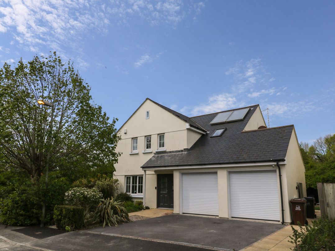A house with a garage and solar panels at Glebe House in Bigbury