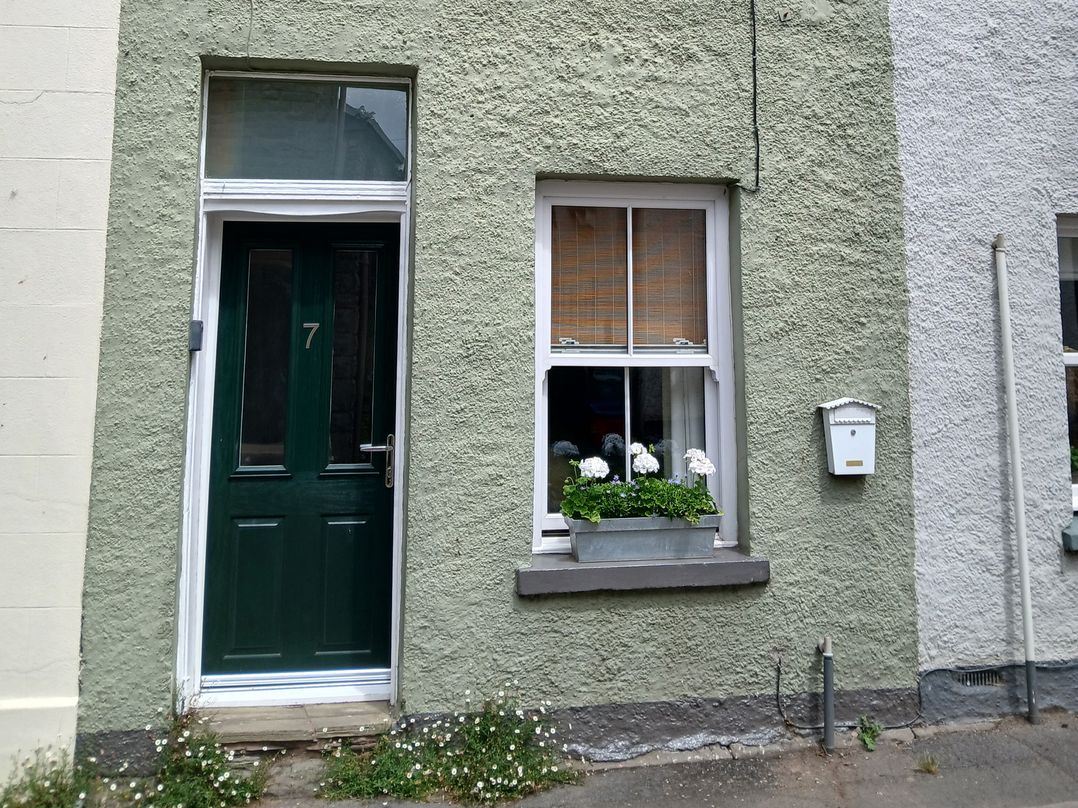 A front door and window with flower box at 7 Bell Street Talgarth