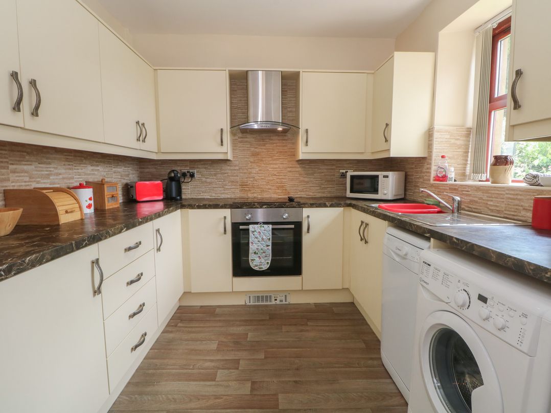 A kitchen with appliances and cabinetry at West End House in Thornton, West Yorkshire