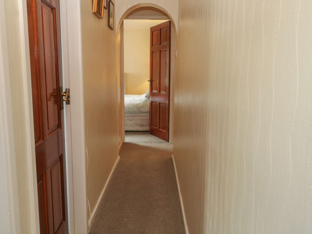 A hallway with doors leading to a bedroom at West End House in Thornton, West Yorkshire