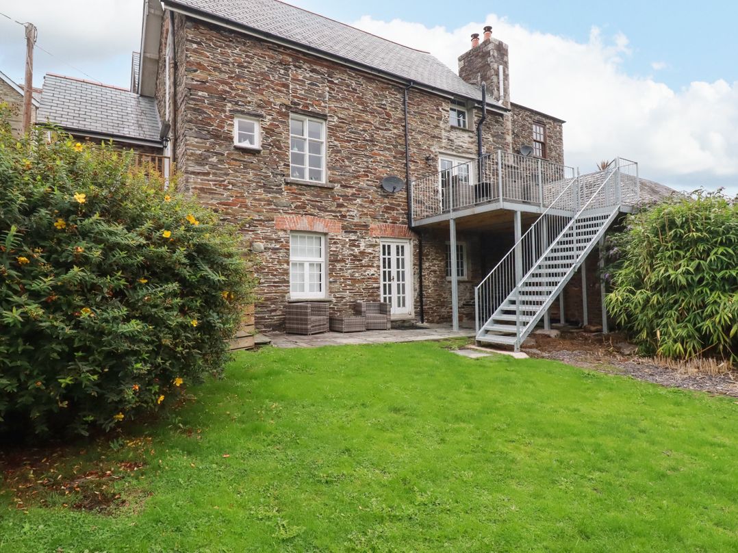 An outdoor view of a building with stairs and garden at Tower House in Boscastle