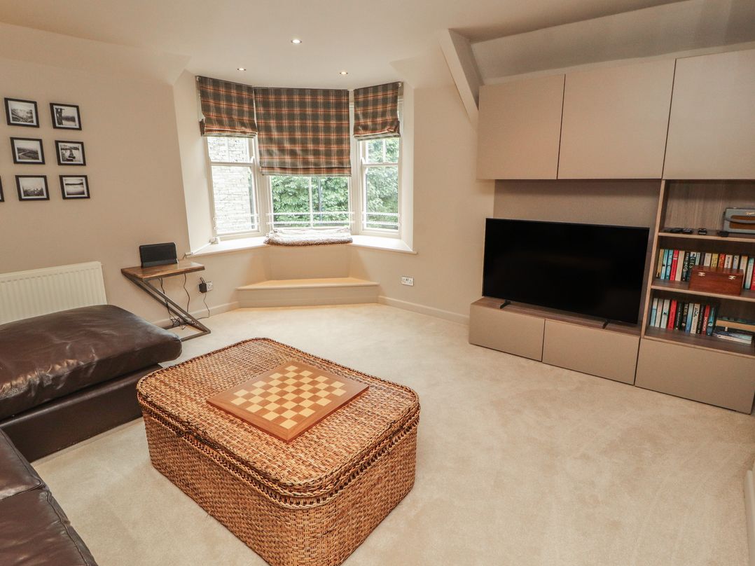 A living room with a coffee table and television at Kelsick Heights in Ambleside